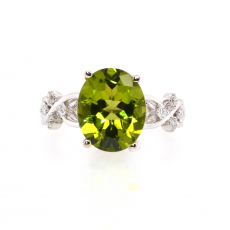 Peridot Oval 1.49 Carat Ring With Accent diamonds in 14k White Gold.