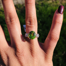 Peridot Oval 1.49 Carat Ring With Accent diamonds in 14k White Gold.